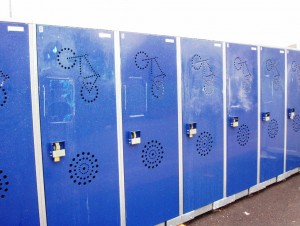 A row of blue vertical bike lockers